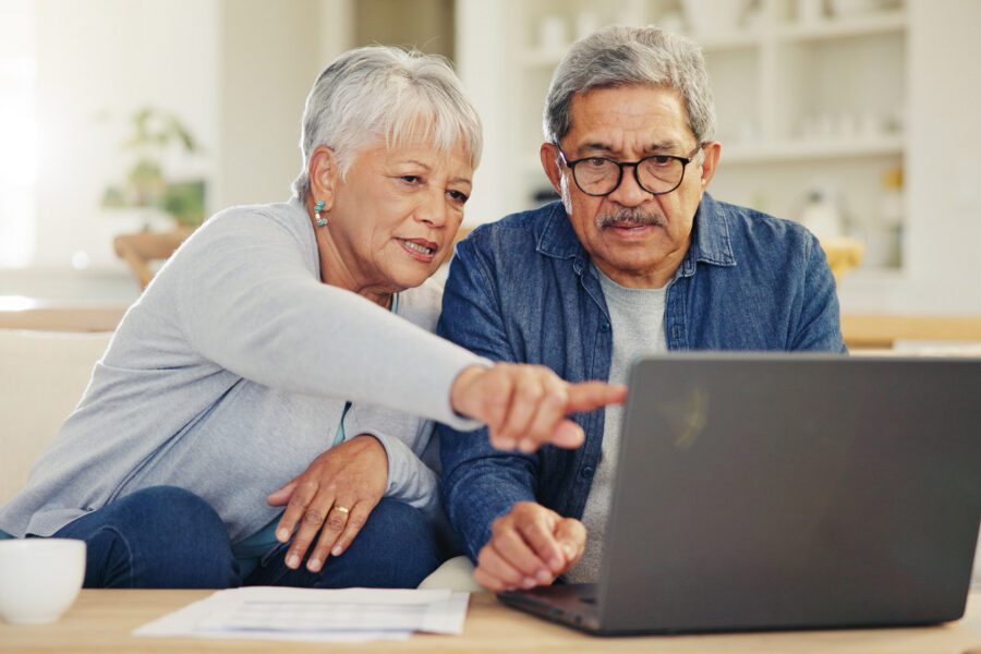 Senior couple looking at laptop